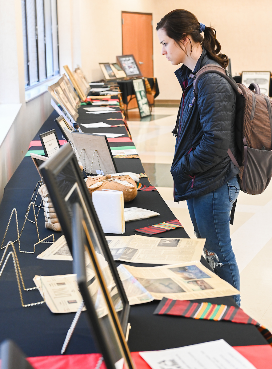 Kara Smith looks at items in the Sankofa African American Museum on Wheels exhibit.